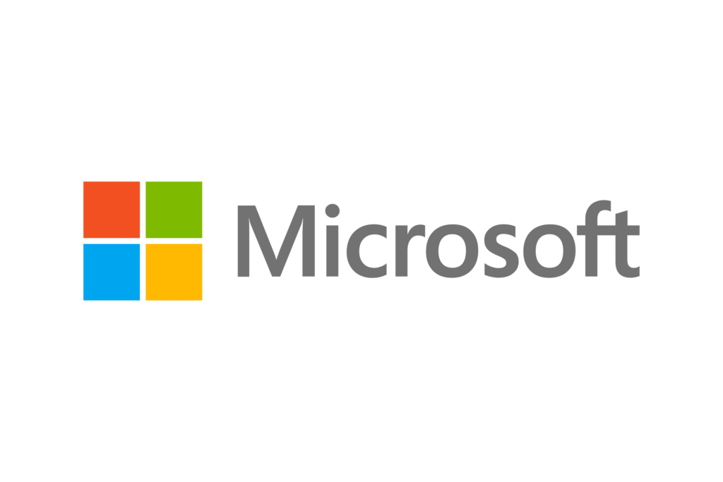 Microsoft logo featuring a four-square, multicolored window design on the left, with each square in red, green, blue, and yellow. The word "Microsoft" is written in gray, sans-serif font to the right of the window design. The background is transparent.