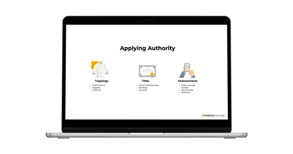 A laptop screen displays a presentation slide titled "Applying Authority." The slide is divided into three sections with icons: "Trappings" (lab coat, diploma), "Titles" (certificate), and "Endorsements" (hand holding a smartphone). - Choice Hacking Academy A laptop screen displays a presentation slide titled "Applying Authority." The slide is divided into three sections with icons: "Trappings" (lab coat, diploma), "Titles" (certificate), and "Endorsements" (hand holding a smartphone).