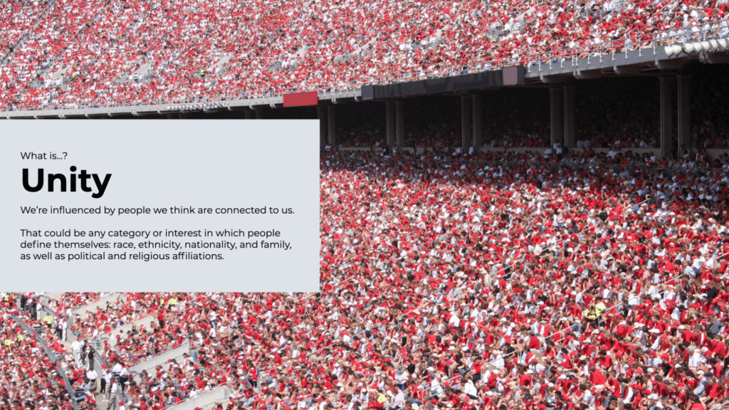 An image of a packed stadium filled with spectators in red attire. Overlaid on the left side is a white box with the title "Unity" in large font, followed by text discussing the concept of unity and how people are influenced by various categories and interests. - Choice Hacking Academy An image of a packed stadium filled with spectators in red attire. Overlaid on the left side is a white box with the title "Unity" in large font, followed by text discussing the concept of unity and how people are influenced by various categories and interests.
