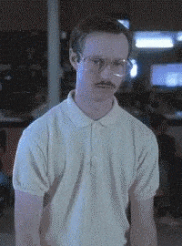 A person with glasses and a mustache, wearing a light-colored polo shirt, is dancing enthusiastically with a serious expression on their face. The background appears to be dark and somewhat blurry, possibly with some lit screens or lights. - Choice Hacking Academy A person with glasses and a mustache, wearing a light-colored polo shirt, is dancing enthusiastically with a serious expression on their face. The background appears to be dark and somewhat blurry, possibly with some lit screens or lights.
