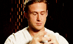 A man in a light shirt closes his eyes, exhales, and rubs his hands together, appearing to feel stressed or overwhelmed. The background is dark with orange-toned lights.